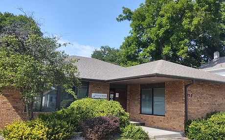 A building with trees and bushes.